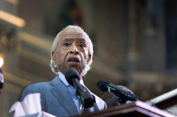 Rev. Al Sharpton speaking at a podium.